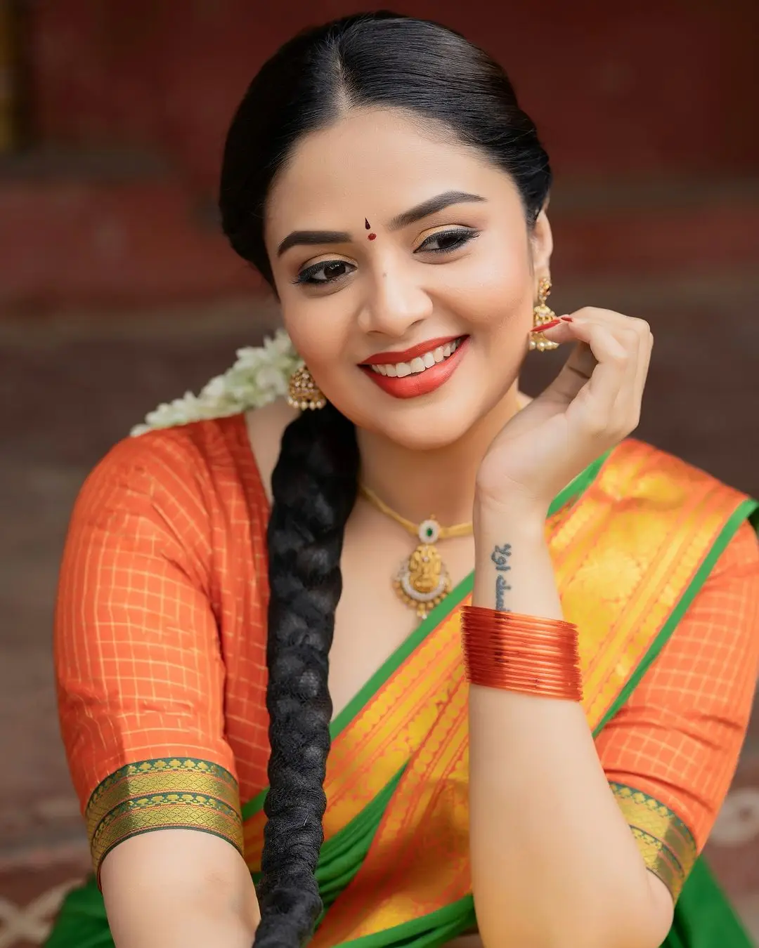 Sreemukhi Stills in Yellow Lehenga Orange Choli Green Voni